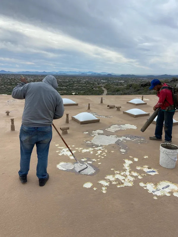 Crew recoating a flat foam roof in Scottsdale