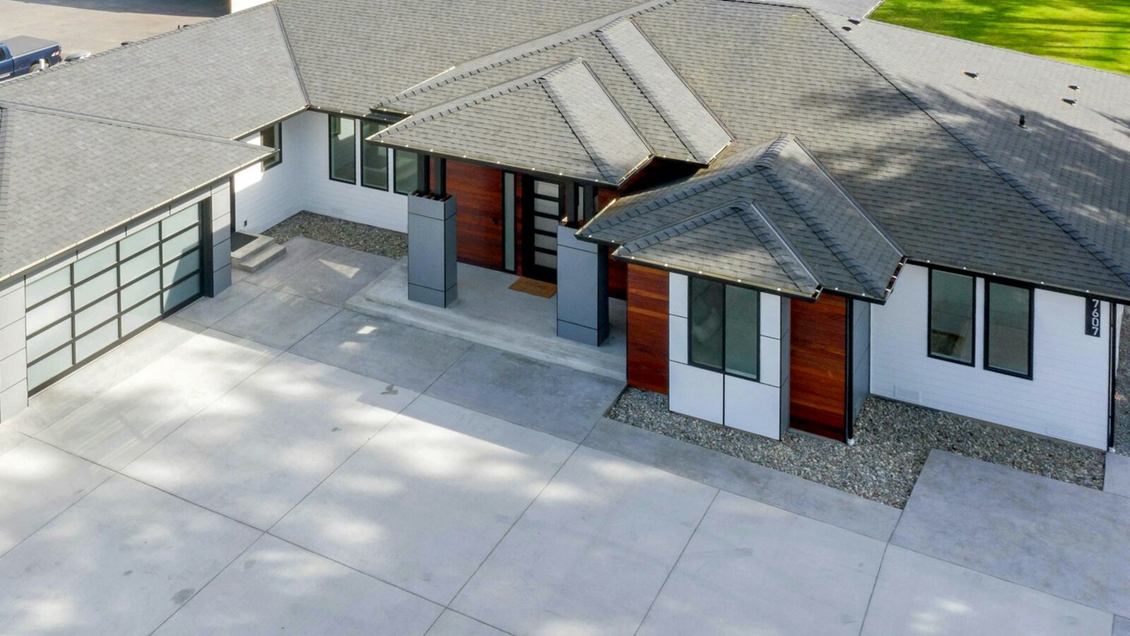 Modern single story home with a grey asphalt shingle roof