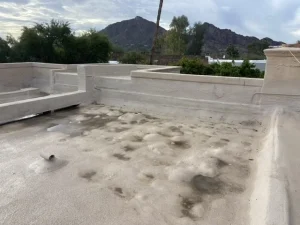 Flat foam roof before repair, blistered and water stained