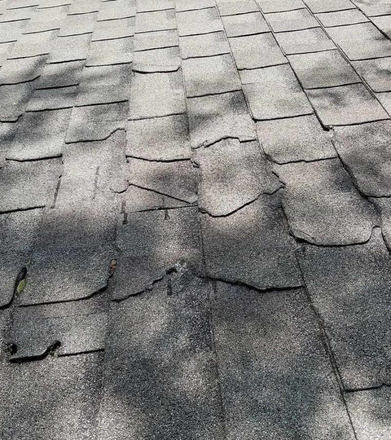 Storm damage across an asphalt shingle roof